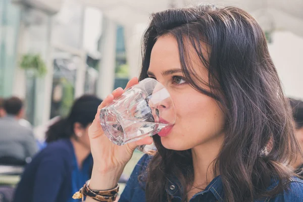 Pretty girl drinking a glass of water — Stock Photo, Image