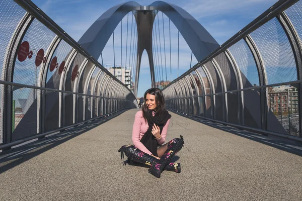 Bella giovane bruna in posa su un ponte — Foto Stock