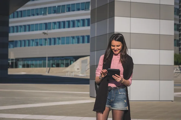 Krásná mladá brunetka pracuje na její tablet — Stock fotografie