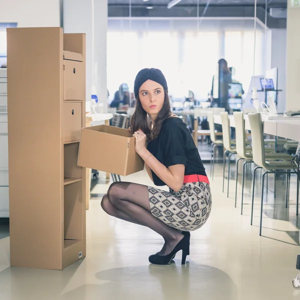 Beautiful young brunette posing in an office — Stock Photo, Image