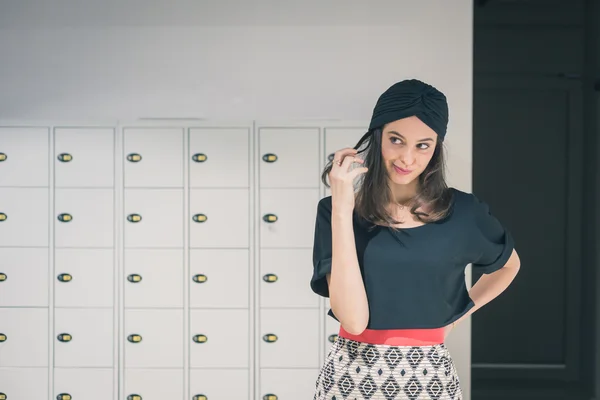 Beautiful young brunette posing in an office — Stock Photo, Image