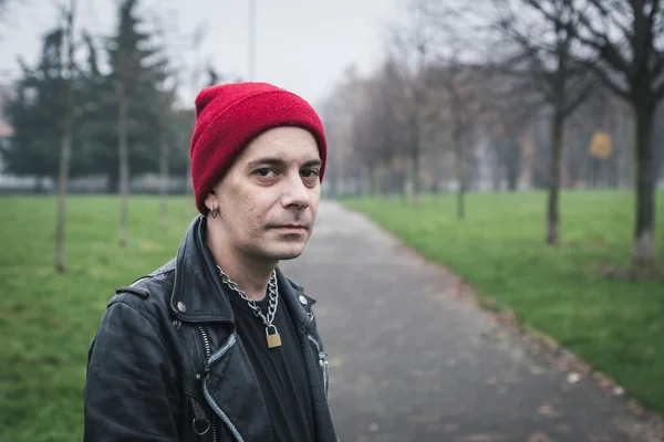 Punk guy posing in a city park — Stock Photo, Image