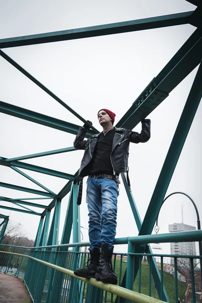 Punk guy standing on a bridge — Stock Photo, Image