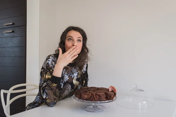 Beautiful young brunette posing with brownies — Stock Photo, Image