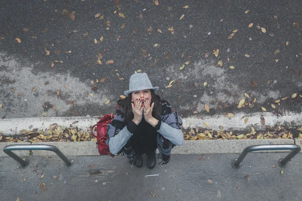 Top view of a beautiful young brunette posing in the city streets — Stock Photo, Image