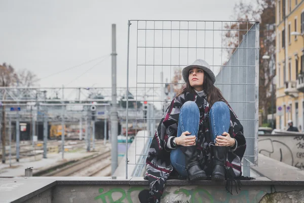 Schöne junge Brünette posiert in den Straßen der Stadt — Stockfoto