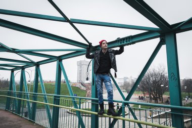Punk guy standing on a bridge clipart