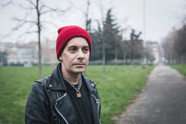 Punk guy posing in a city park — Stock Photo, Image