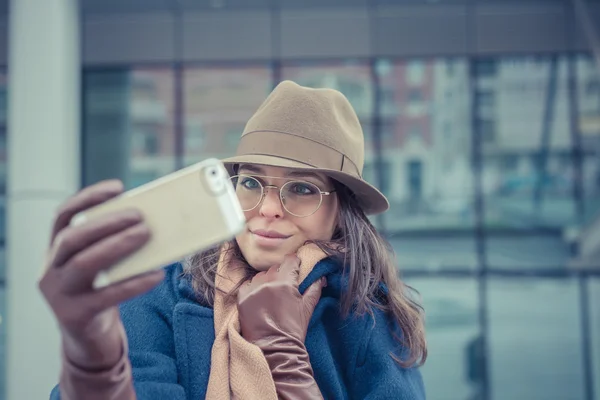 Piękna młoda brunetka przy selfie na ulicach miasta — Zdjęcie stockowe