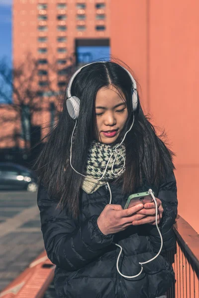 Young beautiful Chinese girl with headphones — Stock Photo, Image