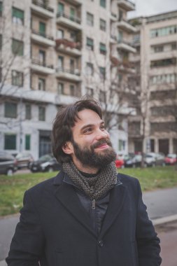 Genç yakışıklı sakallı adam şehir sokaklarını poz