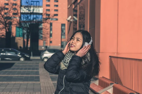 Young beautiful Chinese girl with headphones — Stock Photo, Image