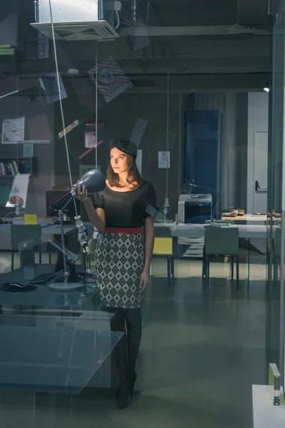 Beautiful young brunette posing in an office — Stock Photo, Image