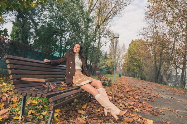 Beautiful young woman posing in a city park — Stock Photo, Image