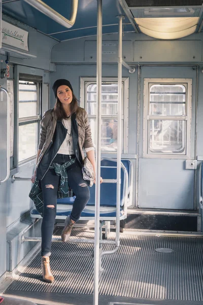 Pretty girl posing in a metro car — Stock Photo, Image