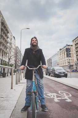 Genç yakışıklı sakallı adam onun bisiklet ile poz