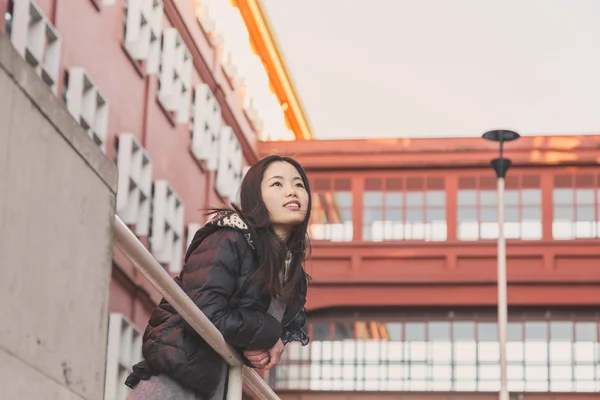 Jonge mooie Chinees meisje poseren in de straten van de stad — Stockfoto