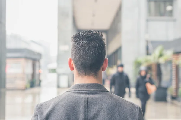 Genç bir adamın şehir sokaklarını poz arkadan görünüm — Stok fotoğraf