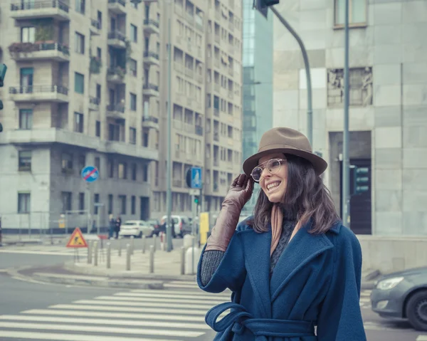 Krásná mladá brunetka pózuje v ulicích města — Stock fotografie