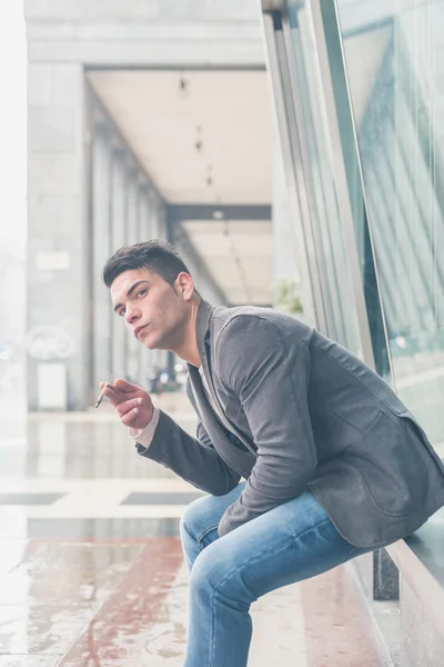 Young handsome man smoking a cigarette — Stock Photo, Image