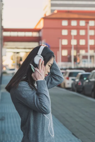 Young beautiful Chinese girl with headphones — Stock Photo, Image