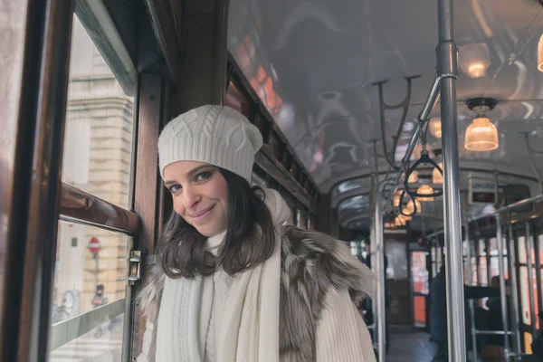 Beautiful young woman posing on a tram — Stock Photo, Image