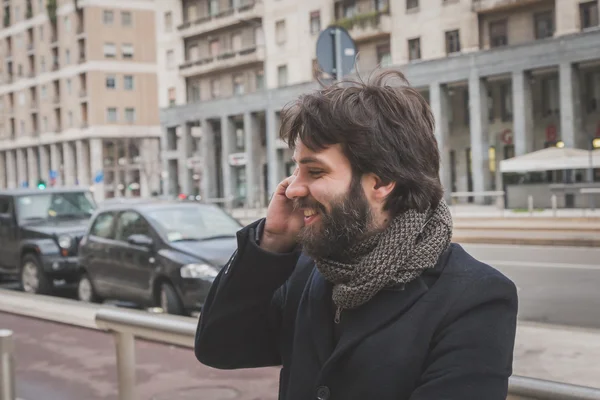 Young handsome bearded man talking on phone — Stock Photo, Image