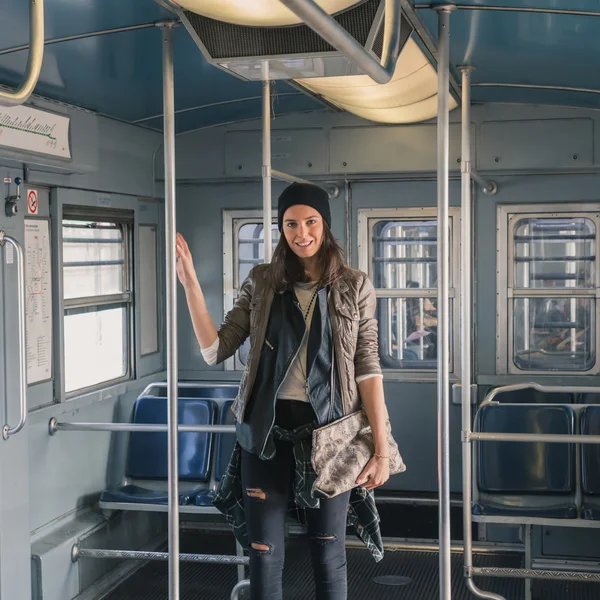 Pretty girl posing in a metro car — Stock Photo, Image