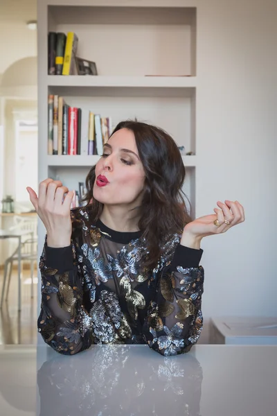 Beautiful young brunette putting on nail polish — Stock Photo, Image