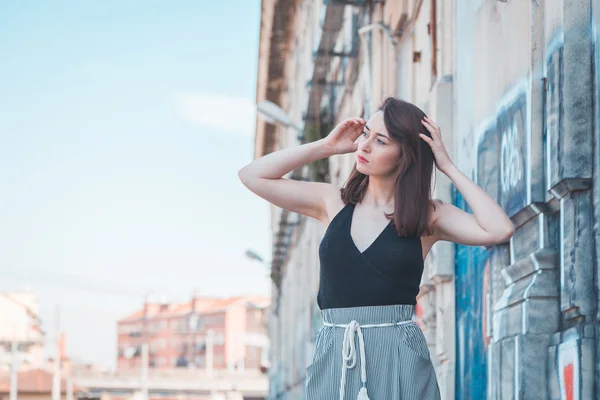 Beautiful brunette posing in an industrial context — Stock Photo, Image