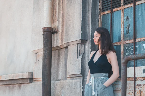 Beautiful brunette posing in an industrial context — Stock Photo, Image