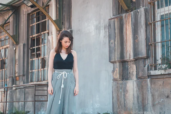 Beautiful brunette posing in an industrial context — Stock Photo, Image