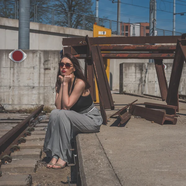 Beautiful brunette posing in an industrial context — Stock Photo, Image