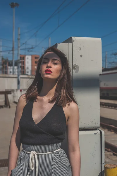 Beautiful brunette posing in an industrial context — Stock Photo, Image