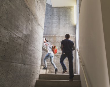 Guys climbing the stairs at Ventura Lambrate space during Milan  clipart