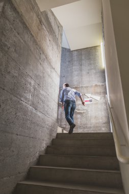 Guy climbing the stairs at Ventura Lambrate space during Milan D clipart