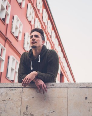 Genç adam bir kentsel bağlamda poz