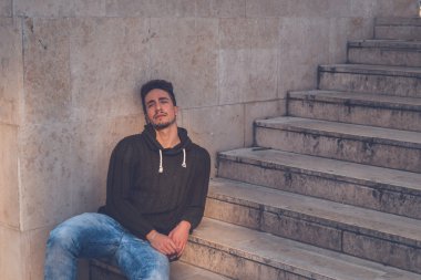 Genç adam bir kentsel bağlamda poz