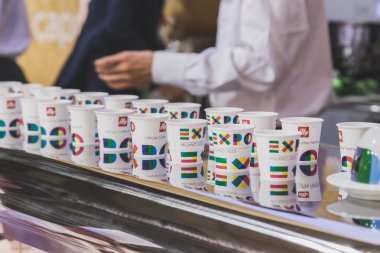 Paper cups with Expo logo at Tuttofood 2015 in Milan, Italy clipart