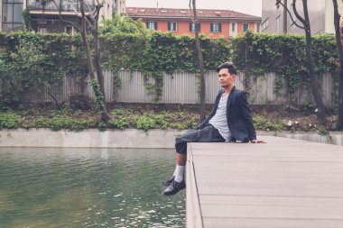 Yakışıklı Asya model tarafından yapay bir havza poz