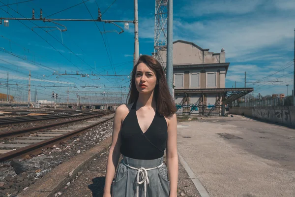 Beautiful brunette posing in an industrial context — Stock Photo, Image