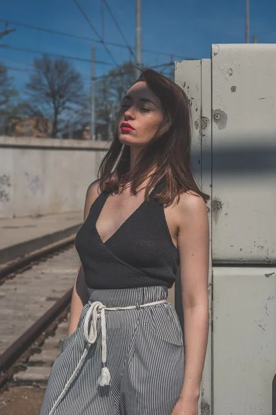 Beautiful brunette posing in an industrial context — Stock Photo, Image