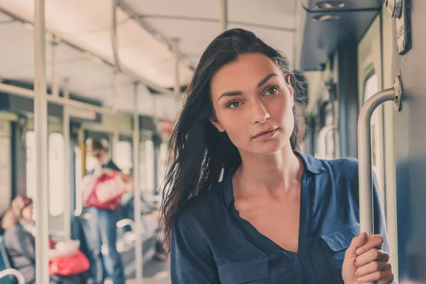 Beautiful girl posing in a metro car — Stock Photo, Image