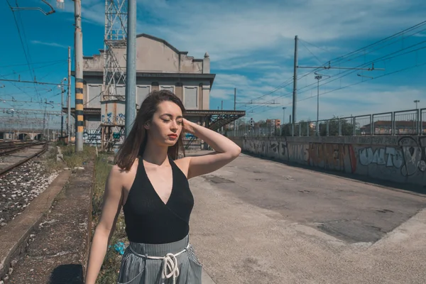 Mooie brunette poseren in een industriële context — Stockfoto