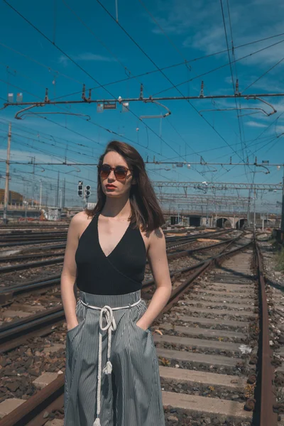 Beautiful brunette posing in an industrial context — Stock Photo, Image