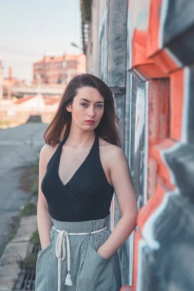 Beautiful brunette posing in an industrial context — Stock Photo, Image