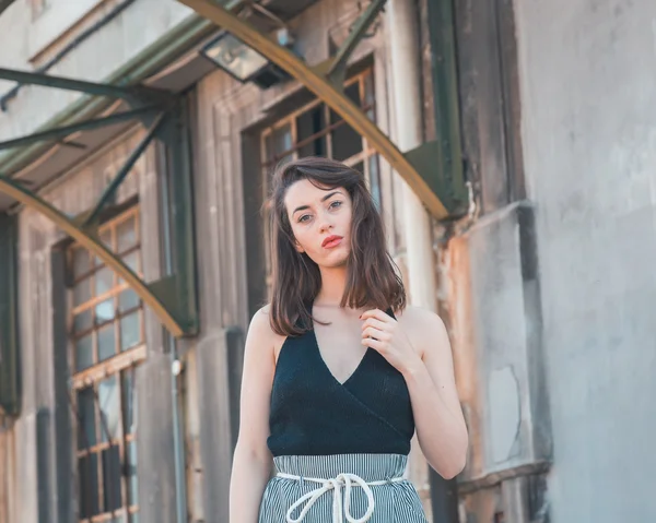 Beautiful brunette posing in an industrial context — Stock Photo, Image