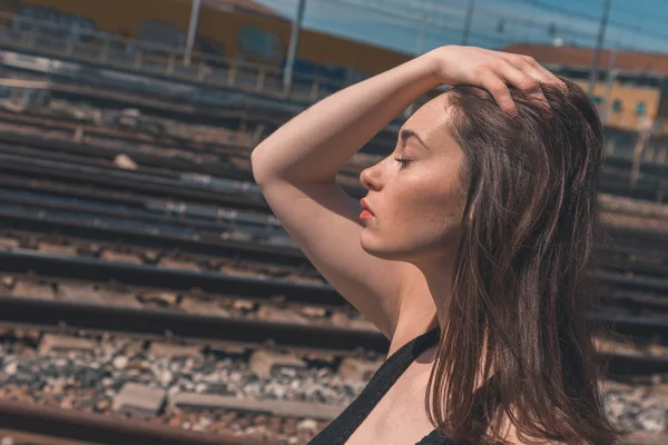 Beautiful brunette posing in an industrial context — Stock Photo, Image