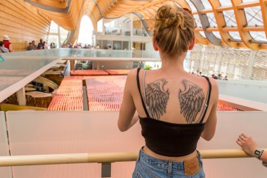 Girl with tattoo visiting China pavilion at Expo 2015 in Milan,  clipart