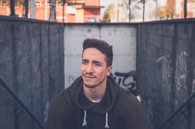Genç adam bir kentsel bağlamda poz